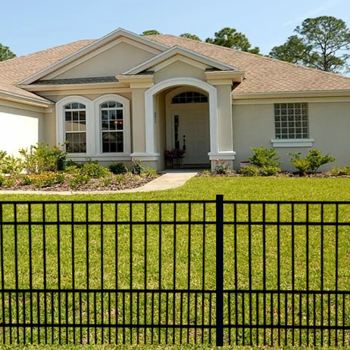 aluminum-fence-outside-home-2 A black aluminum fence bordering the yard of a home.