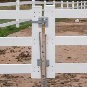 A fence with a double drive gate latch and drop pins.
