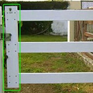 A fence with the gate stile outlined in bright green.