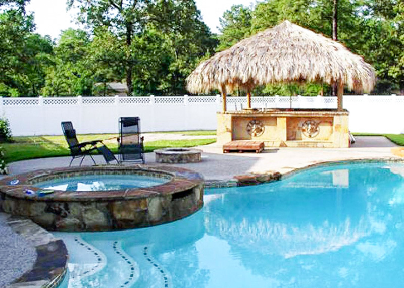 pool-fence-2 A swimming pool with a tiki bar is surrounded by a privacy fence.